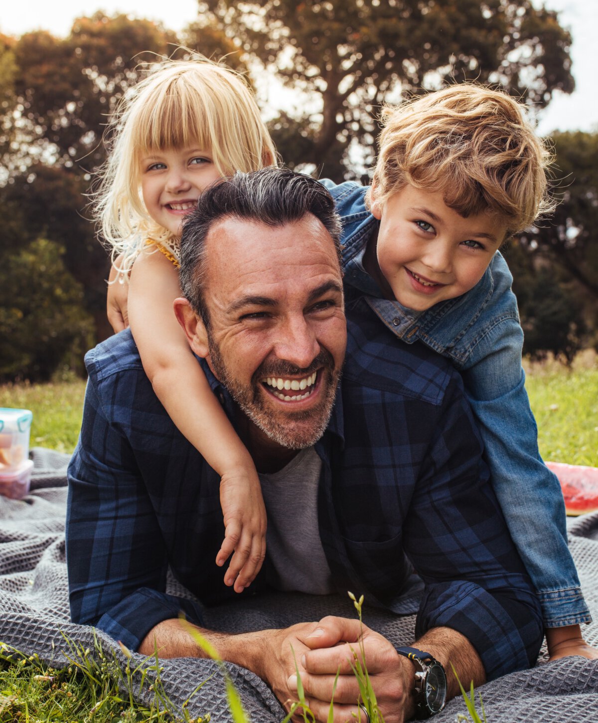 Full Mouth Reconstruction patient model smiling with his two kids