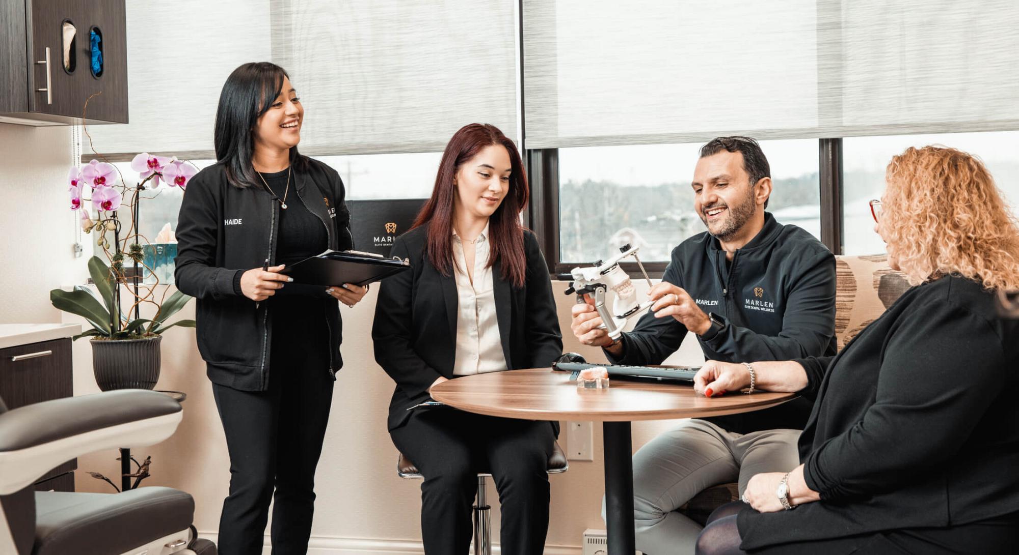 River Edge cosmetic dentist office staff sitting at a table